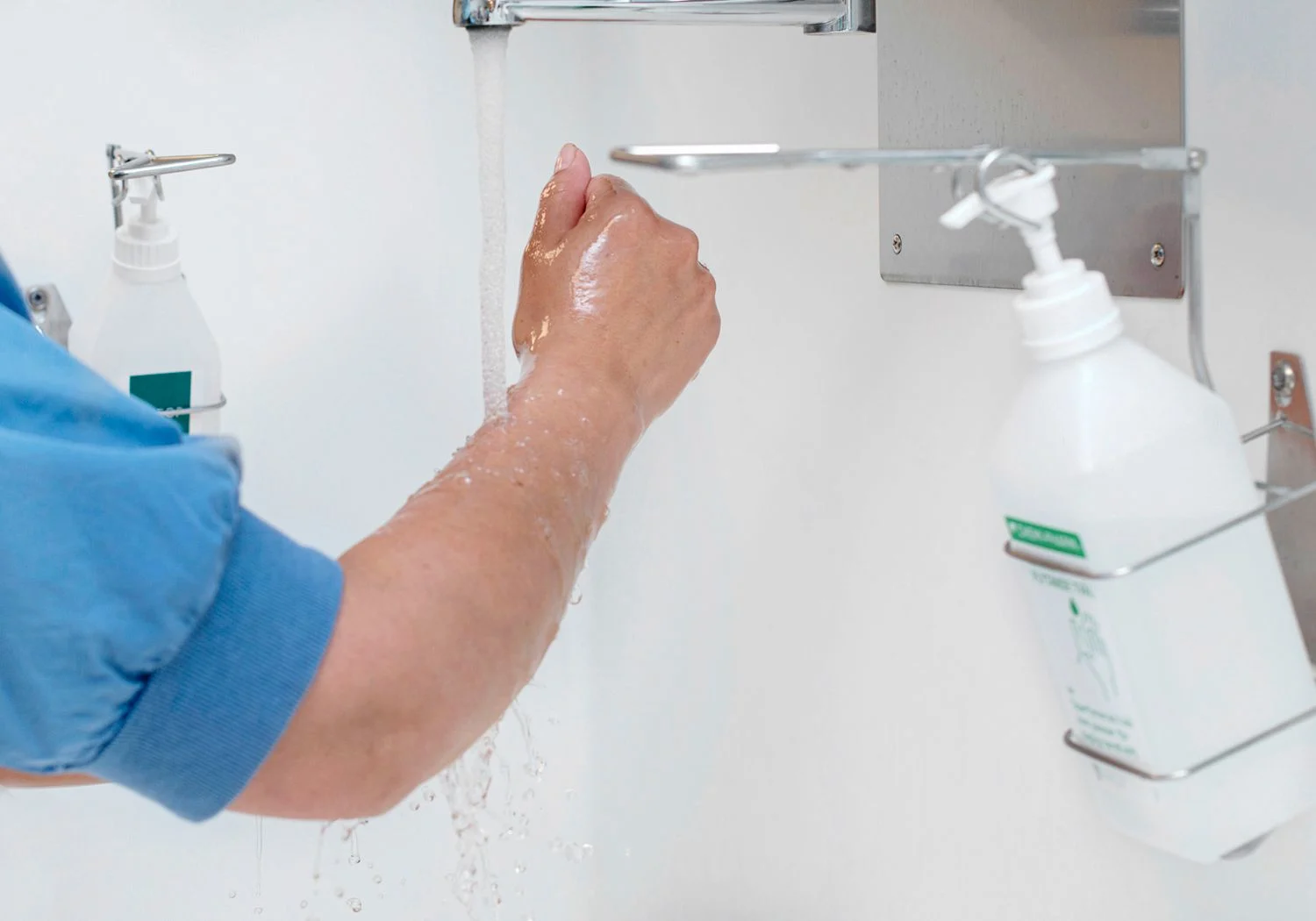 Doktor tar handsprit på sina rentvättade händer.